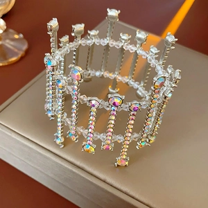 Detailed close-up of a silver crown accessory with sparkling AB rhinestones and crystal beads
