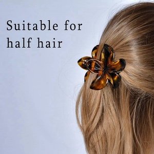 Detail of amber tortoiseshell flower hair claw clip styling half hair for women