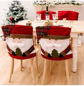 Detailed view of a Santa Claus chair cover with 3D plush details in a festive home setting