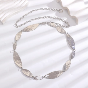 Detail view of silver bohemian metal waist chain with textured leaf-shaped pendants