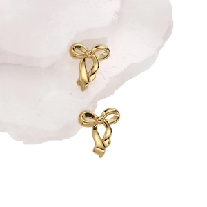 Elegant 18K gold-plated irregular bow stud earrings displayed on white textured stone