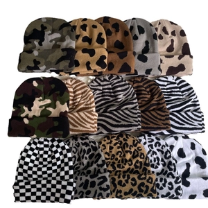 Assorted winter knit beanies featuring leopard, zebra, and cow prints for women