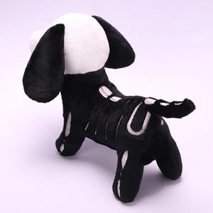 Detail of plush Halloween skeleton dog with white embroidered bone patterns on black fabric