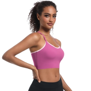 Side view of rose red sports bra with thin straps and contrasting pink trim for yoga