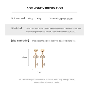 Detail showing 18k gold plated key pendant earrings with zircon and copper dimensions