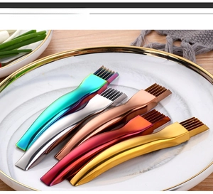 Macro shot of stainless steel scallion slicers in five metallic colors on a plate