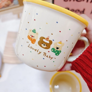 Detailed view of ceramic mug with colorful polka dots, cute bears, and Lovely Baby text