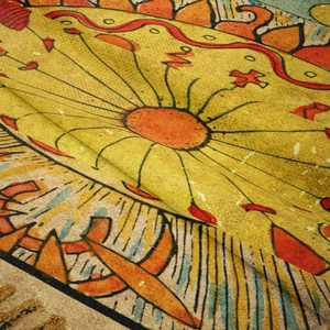Close-up of woven fabric texture with sun totem pattern on bohemian wall tapestry