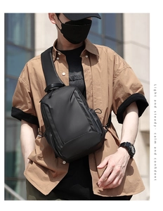 Detail of black matte waterproof chest bag with sturdy zipper and stitching on the strap