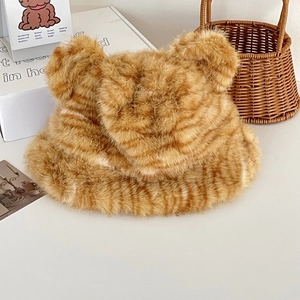 Close-up of brown tiger pattern faux fur bucket hat with cute bear ears for winter