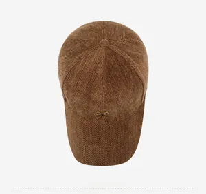 Detailed top view of brown herringbone baseball cap with a gold bow metal buckle