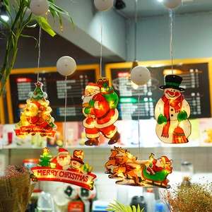 Detail of warm white LED Christmas window suction lights featuring Santa and reindeer designs