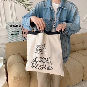 Canvas tote bag with lucky animal print and black webbing handles for daily casual use