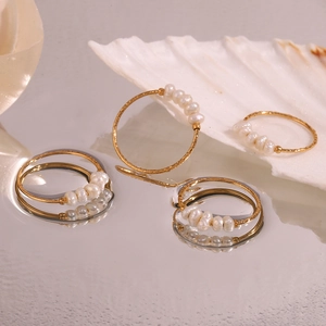 Macro detail of 18K gold plated stainless steel rings with small freshwater pearls
