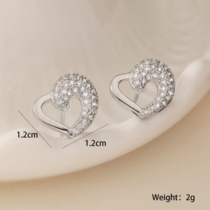 Macro shot of silver heart stud earrings with cubic zirconia, size 1.2cm and weight 2g