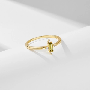 Gold s925 silver ring featuring rectangular green zircon on white wavy pedestal