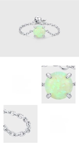 Macro view of S925 sterling silver chain ring featuring a prong-set round opal stone