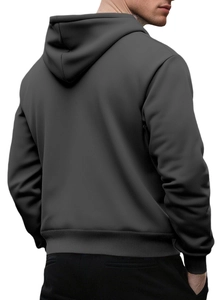 Back view of a solid dark grey oversized hoodie featuring ribbed cuffs and hem details