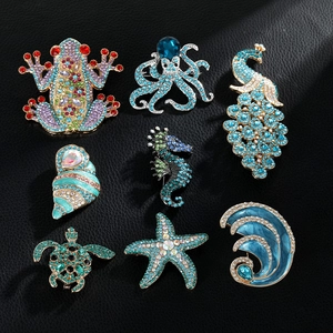 Set of eight colorful ocean-themed rhinestone sea turtle and peacock brooches