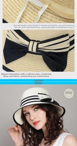 Detail of cream straw hat featuring black and white bow with metal M logo and adjustable cord