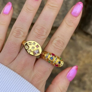 Gold plated signet rings with colorful zircon stars and moon in a natural outdoor setting