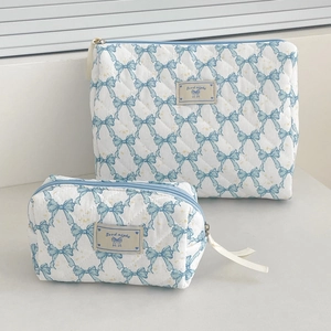 Quilted makeup bag set with blue bow patterns and large capacity storage design