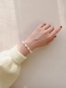 Macro shot of irregular freshwater pearl bracelet showing elegant metallic spacers and textures