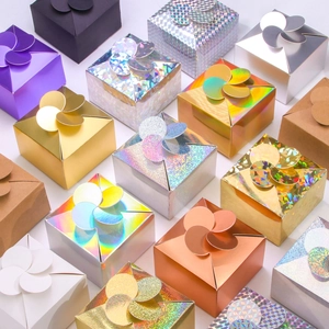 High-angle view of assorted colorful laser paper gift boxes with petal-shaped closures