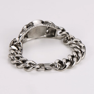 Detailed close-up of retro silver stainless steel Cuban chain bracelet with green agate
