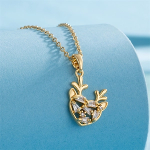 Golden micro-pave zircon reindeer pendant necklace on blue background for women
