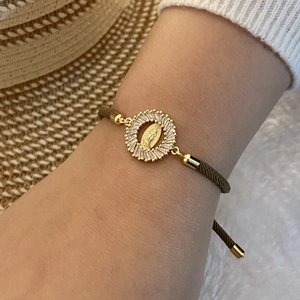 Olive green braided bracelet featuring a gold Virgin Mary pendant with white zircon inlays