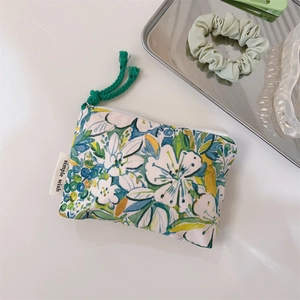 Detail of oil painting style floral cotton pouch with simple wish label and green zipper pull