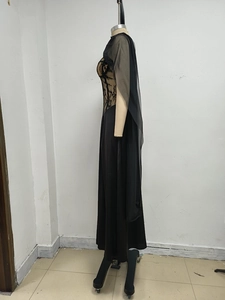 Detail of black lace evening dress featuring a sheer mesh shawl and slim silhouette