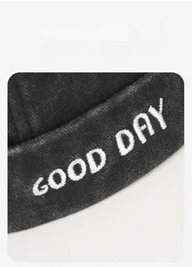 Detail of GOOD DAY white 3D embroidery on washed charcoal black vintage brimless docker hat