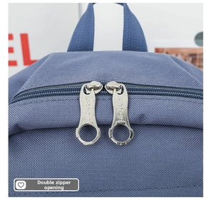 Close-up of blue school backpack featuring dual metal zippers with Sport engraving