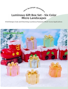 Luminous Christmas gift box miniature set on snow with glowing resin micro landscape