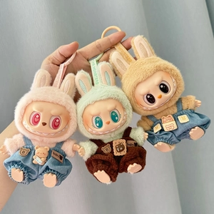 Three colorful plush doll pendants in pink, green, and yellow wearing overalls