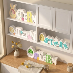 Easter wooden OSTERN letter ornaments with rabbit silhouette and floral painted details