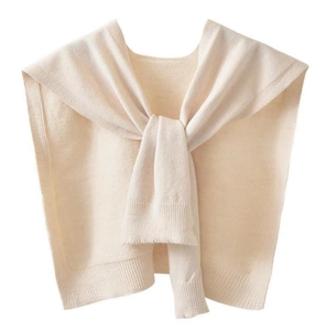 Detail of soft cream knitted shawl wrap showing fine ribbing and stylish knot detail
