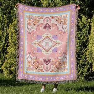 Detail of bohemian knitted camping blanket with colorful tassels and ethnic totem pattern