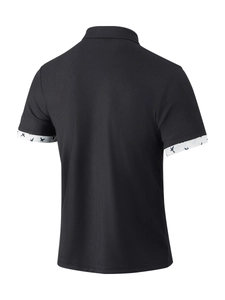Detail of waffle knit fabric and white bird print on black short sleeve polo shirt sleeve