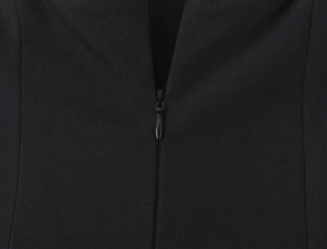 Macro view of seamless invisible zipper detail on the black strapless dress fabric