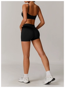 Rear view of black yoga set featuring racerback sports bra and high-waisted shorts