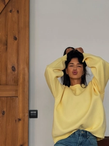 Bright yellow oversized knit sweater with a crew neck and relaxed drop shoulder design