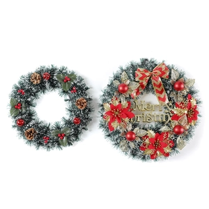 Christmas wreaths with pine needles, red berries, cones, and Merry Christmas sign