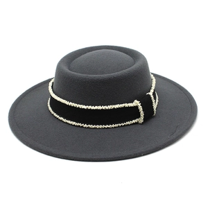Close-up of dark grey wool felt fedora with elegant black ribbon and pearl trim details
