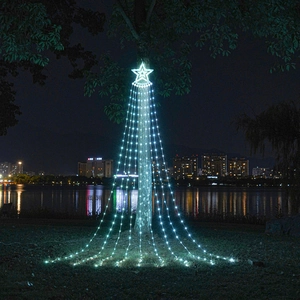Cold white LED star waterfall lights hanging on a tree with scenic lake reflection
