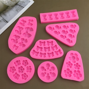 Pink silicone mold set featuring assorted floral and bow designs for DIY cake decor