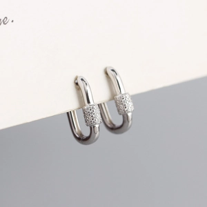 Macro shot of silver U-shaped geometric buckle earrings with pavé cubic zirconia