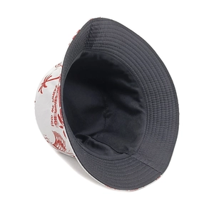 Detail showing tropical palm tree print and reversible fabric of this summer bucket hat